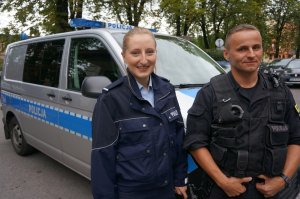 Policjantka z Niemiec wraz z polskim policjantem na tle radiowozu