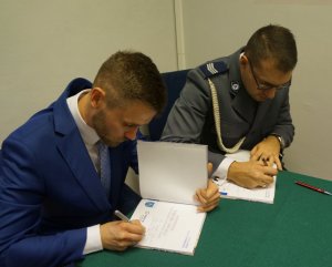 Na zdjęciu oficer prasowy jednostki oraz Leszek Bensz podpisujący wydane książki