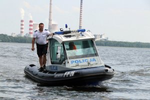 Łódź motorowodna, umundurowany policjant pełniący służbę w patrolu Sezonowej Komórki Specjalistycznej Policji.
