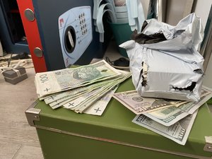 Banknoty znajdujące się na skrzyni i pieniądze w woreczku.