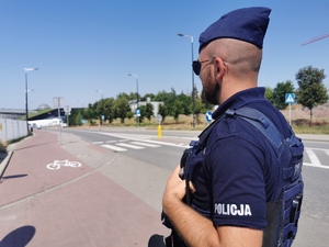 policjant prewencji patrzy w kierunku zabezpieczanej trasy