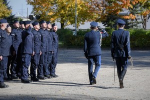 Zdjęcie. Widoczni umundurowani policjanci na placu