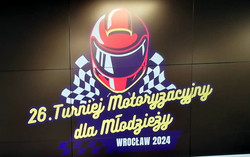 Plakat przedstawiający sylwetkę motocykla oraz motoru.