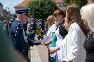 Zastępca komendanta głównego wręcza medale pracownikom cywilnym