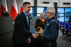 na zdjęciu generał dziękujący mężczyźnie za udział w konferencji, przekazuje pamiątkową tabliczkę trzymając dłoń mężczyzny w serdecznym uścisku.