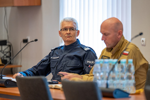 na zdjęciu komendant wojewódzki i strażak przy stole