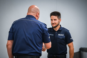 na zdjęciu zastępca komendanta w trakcie uścisku dłoni z innym policjantem