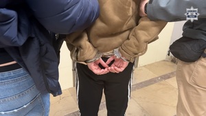 policjanci doprowadzający osobę zatrzymaną