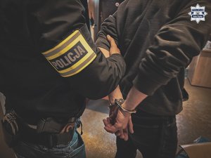 nieumundurowany policjant prowadzi osobę zatrzymaną