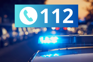 na zdjęciu numer alarmowy sto dwanaście i policyjne światła
