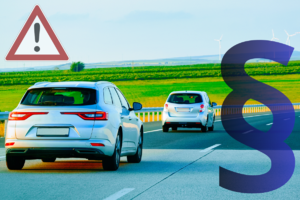 Na grafice widoczne dwa samochody jadące drogą