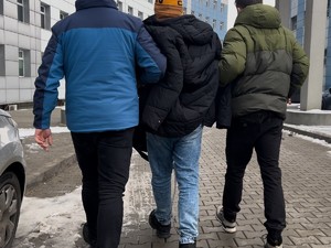 Policjanci w cywilu prowadzą zatrzymanego