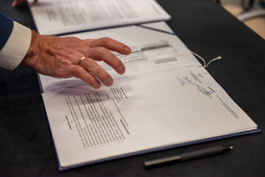 Zdjęcie przedstawia dokumenty porozumienia rozłożone na stole.