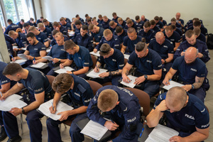 policjanci siedzą i rozwiązują test