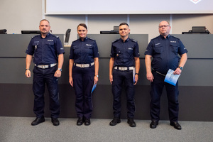 Zdjęcie przedstawia czterech pozujących policjantów