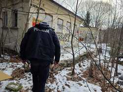 na zdjęciu policjant idący przez teren nieużytków