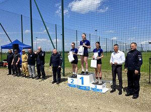 trzy biegaczki stojące na podium obok bytomski komendant i mundurowi z drugiej strony prezydent miasta Bytomia i kolejny mundurowy