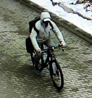 Zdjęcie z monitoringu na którym widać mężczyznę odjeżdżającego na rowerze