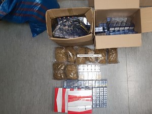 Na zdjęciu paczki papierosów i tytoń w workach