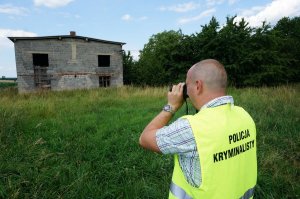 Technik kryminalistyki przed jednym z obiektów w Pierśćcu