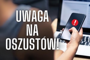 napis UWAGA NA OSZUSTÓW, widoczna dłoń trzymająca telefon smartfona