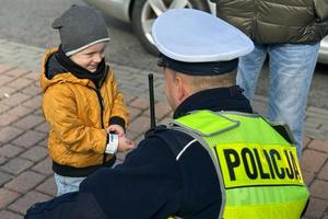 dziecko uśmiecha się do policjanta, dzień