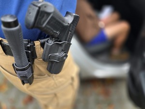 policjant prowadzi zatrzymanego