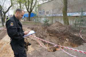 Policjant z zespołu rozpoznania minersko - pirotechnicznego z psem służbowym.