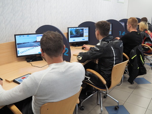 uczestnicy eventu siedzą przed monitorami komputerów podczas pisania testu wiedzy