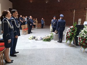 Policjant i policjantka stoją w kościele podczas mszy