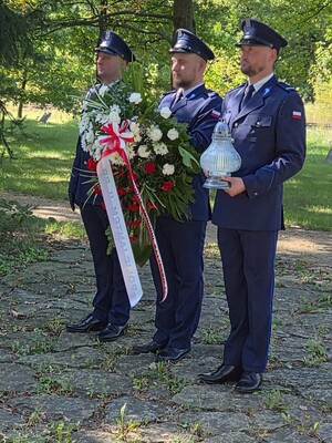 Delegacja policjantów z wiązanką kwiatów