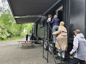 Ludzie wchodzący po schodach do przyczepy ciężarówki