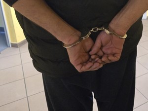 Ręce zatrzymanego w kajdankach zapiętych z tyłu