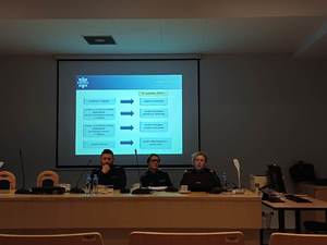 Na zdjęciu trzech policjantów siedzi na podium prowadząc wykłady.