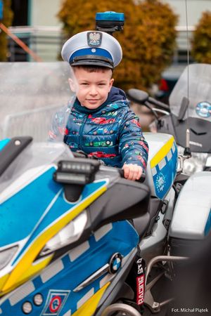 Zdjęcie przedstawiające dziecko na policyjnym motocyklu.