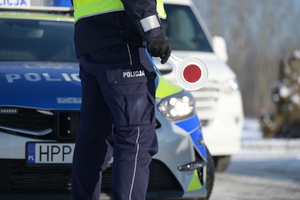 Zdjęcie policjanta ruchu drogowego trzymającego tarczę do zatrzymywania pojazdów.