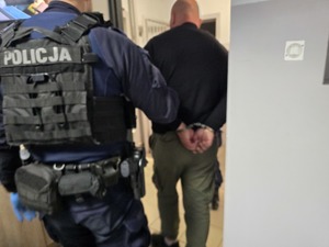 Zdjęcie przedstawiające policjanta oraz osobę zatrzymaną.