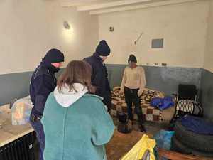 Zdjęcie przedstawiające policjantów, pracownika Ośrodka Pomocy Społecznej oraz mężczyznę.