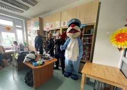 zdjęcie kolorowe przedstawiające policjantów oraz Sznupka podczas spotkania w Górnośląskim Centrum Zdrowia Dziecka