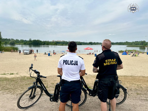 zdjęcie przedstawia policjantów w trakcie rozmowy z plażowiczami