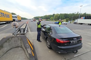 zdjęcie przedstawia policjantów w trakcie kontroli trzeźwości na autostradzie