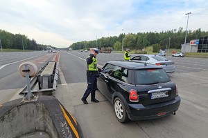 zdjęcie przedstawia policjantów w trakcie kontroli trzeźwości na autostradzie