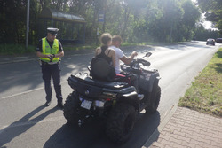 zdjęcie przedstawia policjanta w trakcie kontroli drogowej