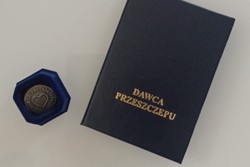 zdjęcie przedstawia legitymację dawcy przeszczepu i odznakę