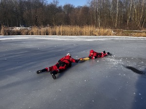 Zdjęcia policjantów z ćwiczeń na zamarzniętym zbiorniku wodnym wraz ze strażą pożarną, Wodnym Ochotniczym Pogotowiem Ratunkowym oraz Strażą Miejska