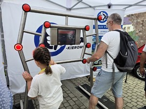 Zdjęcie przedstawia: rodzinę grającą na symulatorze refleksu