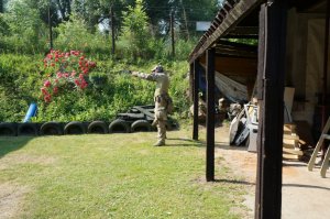 Policjant w pozycji do oddania strzału na strzelnicy