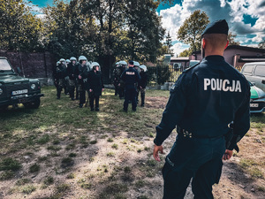 zdjęcie przedstawia szkolenie strażników granicznych - jeden z policjantów omawia ze strażnikami kolejny układ, drugi stoi dalej przyglądając się im