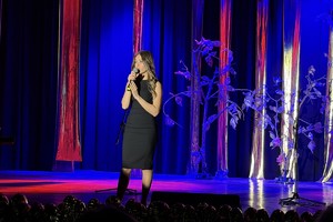 Zdjęcie przedstawia uczennicę podczas występu na scenie.