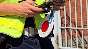 zdjęcie przedstawia policjanta sprawdzającego dokumenty